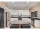 Eat-in kitchen showcasing an island with seating, stainless appliances, and chic mosaic backsplash at 6640 W Honeysuckle Dr, Phoenix, AZ 85083