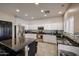 Modern kitchen featuring granite countertops, stainless steel appliances, white cabinets and a stylish mosaic backsplash at 6640 W Honeysuckle Dr, Phoenix, AZ 85083