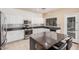 Bright, eat-in kitchen with an island, stainless steel appliances, and a mosaic tile backsplash at 6640 W Honeysuckle Dr, Phoenix, AZ 85083