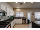 Bright kitchen featuring granite counters, stainless steel appliances, tile backsplash, and ample cabinet space at 6640 W Honeysuckle Dr, Phoenix, AZ 85083