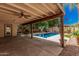 Relaxing backyard with a covered patio overlooking a swimming pool and greenery at 6640 W Honeysuckle Dr, Phoenix, AZ 85083