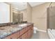 Bathroom features granite counters, modern fixtures, framed mirrors, and glass enclosed shower at 7295 N Scottsdale Rd # 1004, Paradise Valley, AZ 85253