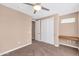 Bedroom with closet, desk, neutral carpeting, and a ceiling fan at 7295 N Scottsdale Rd # 1004, Paradise Valley, AZ 85253