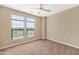 Well-lit bedroom features large windows, neutral carpeting, and a ceiling fan at 7295 N Scottsdale Rd # 1004, Paradise Valley, AZ 85253