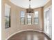 Sunlit dining room with a modern chandelier, large windows, and seamless hardwood floors at 7295 N Scottsdale Rd # 1004, Paradise Valley, AZ 85253