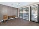 A bright living room with a ceiling fan and ample natural light from a large window at 7295 N Scottsdale Rd # 1004, Paradise Valley, AZ 85253