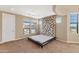 Spacious main bedroom featuring a ceiling fan, carpet, and large windows for natural light at 7295 N Scottsdale Rd # 1004, Paradise Valley, AZ 85253