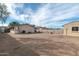 An expansive dirt backyard features a detached building and block perimeter fencing at 744 E Meadow Ln, Phoenix, AZ 85022