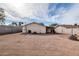 A spacious dirt backyard is completely fenced in with block and includes an outbuilding at 744 E Meadow Ln, Phoenix, AZ 85022