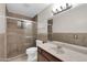 Bathroom featuring a glass door shower, tile accents and a single sink vanity at 744 E Meadow Ln, Phoenix, AZ 85022