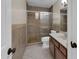 Bathroom featuring a shower-tub combination with decorative tiling and a single sink vanity at 744 E Meadow Ln, Phoenix, AZ 85022