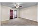 Bedroom featuring neutral walls, carpet flooring, ceiling fan and french doors with access to the exterior at 744 E Meadow Ln, Phoenix, AZ 85022