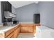 Kitchen featuring tile flooring, wood cabinets, a mini-fridge and ample counter space at 744 E Meadow Ln, Phoenix, AZ 85022