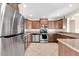 Functional kitchen with stainless steel appliances, tile floors, and ample cabinet space at 744 E Meadow Ln, Phoenix, AZ 85022