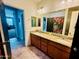 Bathroom featuring double sinks with granite countertop, tile flooring and a shower with floral patterned curtain at 7609 W Whitehorn Trl, Peoria, AZ 85383