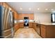 Modern kitchen featuring stainless steel appliances, granite countertops, and ample cabinet space at 7609 W Whitehorn Trl, Peoria, AZ 85383