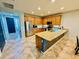 Inviting kitchen area featuring stainless appliances, an island with granite countertop, and tile flooring at 7609 W Whitehorn Trl, Peoria, AZ 85383