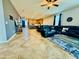 Open-concept living room featuring a black leather sectional and modern design elements at 7609 W Whitehorn Trl, Peoria, AZ 85383