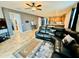 Spacious living room featuring a black leather sectional, ceiling fan, and open kitchen at 7609 W Whitehorn Trl, Peoria, AZ 85383