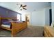 Spacious bedroom with purple accent wall, ceiling fan, and natural light at 7609 W Whitehorn Trl, Peoria, AZ 85383