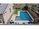 Aerial view of a fenced backyard with a pool, artificial turf, and outdoor seating areas at 7609 W Whitehorn Trl, Peoria, AZ 85383