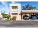 Beige two story condo with a two car covered parking and landscaped yard under a sunny blue sky at 7830 E Park View Dr, Mesa, AZ 85208