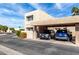 Beige two story condo with a two car covered parking and landscaped yard under a sunny blue sky at 7830 E Park View Dr, Mesa, AZ 85208