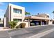 Beige two story condo with a two car covered parking and landscaped yard under a sunny blue sky at 7830 E Park View Dr, Mesa, AZ 85208