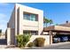 Beige two story condo with a two car covered parking and landscaped yard under a sunny blue sky at 7830 E Park View Dr, Mesa, AZ 85208