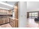 Charming kitchen featuring wood cabinets, granite counters, and seamless access to the adjacent living room at 7830 E Park View Dr, Mesa, AZ 85208