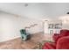 Living room with tile flooring, red and green arm chairs, with a view to the kitchen at 7830 E Park View Dr, Mesa, AZ 85208