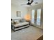 A well lit bedroom with a daybed and french doors that lead to a balcony at 804 W Village Pkwy, Litchfield Park, AZ 85340