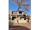 Charming two-story home with stone accents, a pergola-covered porch, and desert landscaping at 804 W Village Pkwy, Litchfield Park, AZ 85340