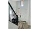 Bright foyer featuring wood-look floors and a staircase with iron railing at 804 W Village Pkwy, Litchfield Park, AZ 85340