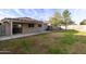 This backyard features a covered patio, grassy lawn, and a block wall fence providing a private outdoor space at 8434 E Natal Cir, Mesa, AZ 85209