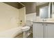 Bathroom features tile floor, a tub and shower combo, white toilet, and a vanity with a sink and neutral countertop at 8434 E Natal Cir, Mesa, AZ 85209