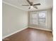 Bedroom with hardwood floors and a large window offering natural light, creating a bright and airy atmosphere at 8434 E Natal Cir, Mesa, AZ 85209