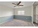 Bright bedroom features blue and white accents, neutral carpet, and a large closet for storage at 8434 E Natal Cir, Mesa, AZ 85209