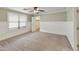 Cozy bedroom with carpeted floors, neutral walls, ceiling fan, and a window providing natural light at 8434 E Natal Cir, Mesa, AZ 85209