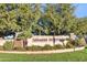 Landscaped entrance to LeSueur Estates showcasing lush greenery and a welcoming neighborhood feel at 8434 E Natal Cir, Mesa, AZ 85209