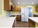 A full view of the kitchen showing a white refrigerator and lots of cabinet space at 8434 E Natal Cir, Mesa, AZ 85209