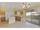 Bright eat-in kitchen featuring wood cabinets, a center island, and sliding glass doors to the back at 8434 E Natal Cir, Mesa, AZ 85209