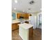 Well-lit kitchen features ample cabinet space and a functional island with a white countertop at 8434 E Natal Cir, Mesa, AZ 85209