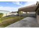 Concrete patio with an overhead pergola and a grassy, enclosed backyard creates an inviting outdoor space at 8434 E Natal Cir, Mesa, AZ 85209