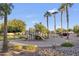 A playground with a slide and climbing structure within a sandy area provides recreational options for the community at 8434 E Natal Cir, Mesa, AZ 85209