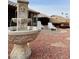 Backyard water fountain feature surrounded by decorative rock, with outdoor seating and a hot tub in the background at 8536 W Rockwood Dr, Peoria, AZ 85382