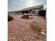 Expansive backyard featuring red rock landscaping, hot tub, and mature greenery for relaxed outdoor living at 8536 W Rockwood Dr, Peoria, AZ 85382