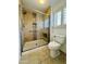 Bathroom with tiled shower, seat, and toilet at 8536 W Rockwood Dr, Peoria, AZ 85382