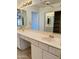 Bathroom featuring double vanity sinks, a large mirror, and storage cabinets at 8536 W Rockwood Dr, Peoria, AZ 85382