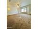 Spacious bedroom featuring carpet flooring, sconce lighting, plantation shutters, and ample natural light at 8536 W Rockwood Dr, Peoria, AZ 85382